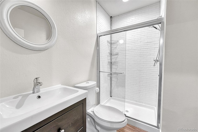 1903 W 66th Ave, Denver, CO 80221 - bathroom featuring a shower stall, a textured wall, vanity, and wood finished floors
