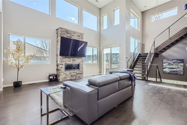 28424 Tepees Way, Evergreen, CO 80439 - living area with a high ceiling, dark wood-style flooring, stairway, and healthy amount of natural light