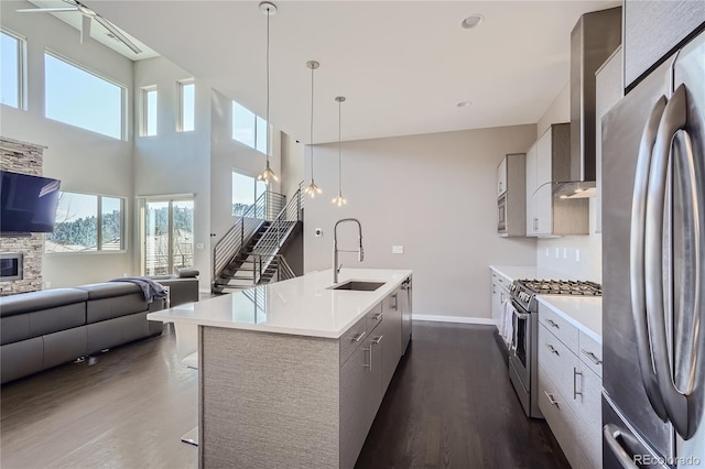 28424 Tepees Way, Evergreen, CO 80439 - kitchen with appliances with stainless steel finishes, wall chimney range hood, modern cabinets, dark wood-style floors, and open floor plan