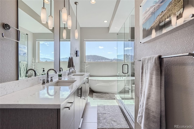 28424 Tepees Way, Evergreen, CO 80439 - full bathroom with a soaking tub, double vanity, tile patterned flooring, recessed lighting, and a shower with shower door