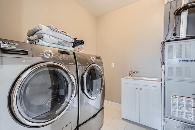28424 Tepees Way, Evergreen, CO 80439 - laundry area featuring washing machine and clothes dryer, cabinet space, and light tile patterned floors