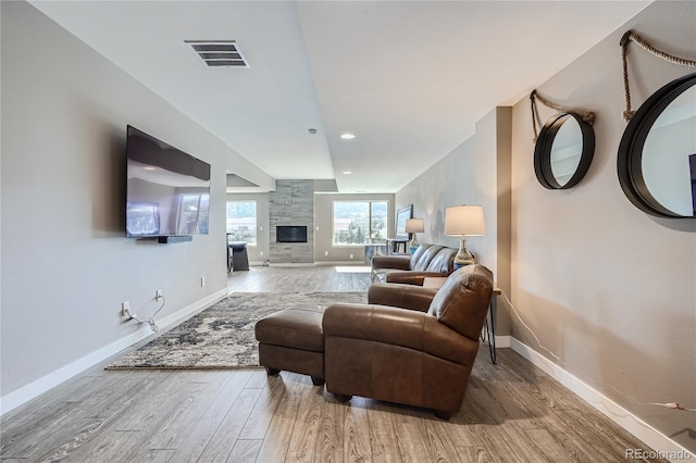 28424 Tepees Way, Evergreen, CO 80439 - living room featuring wood finished floors, a fireplace, and recessed lighting