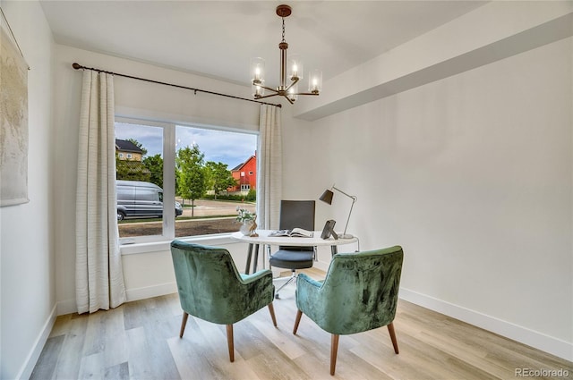 office space featuring baseboards, an inviting chandelier, and wood finished floors