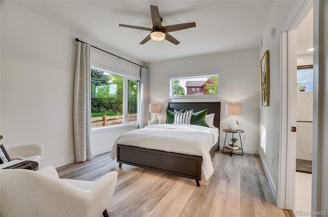 bedroom with light wood finished floors, ceiling fan, and baseboards