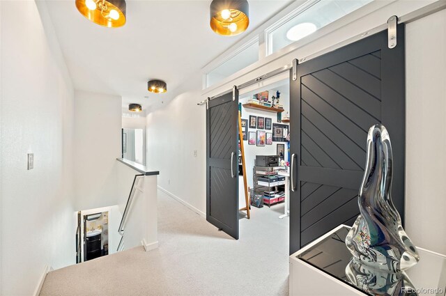 4150 Longview Ln, Boulder, CO 80301 - hallway featuring a barn door, an upstairs landing, carpet floors, and baseboards