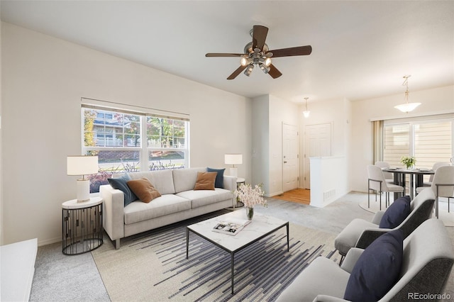 living room with ceiling fan and light colored carpet