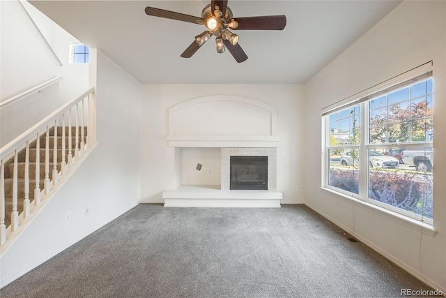 unfurnished living room with ceiling fan and carpet floors