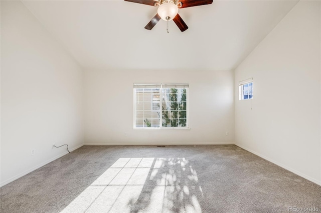 empty room featuring ceiling fan, light colored carpet, and vaulted ceiling