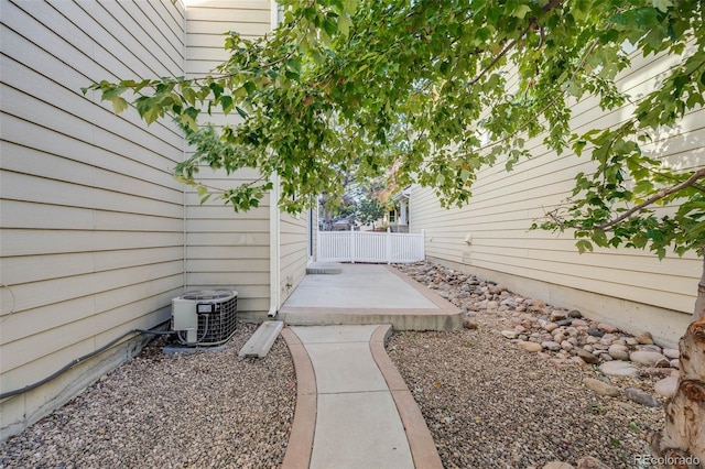 view of yard with central AC unit and a patio