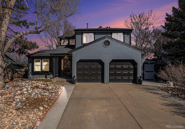 view of front of house with brick siding, a garage, and driveway