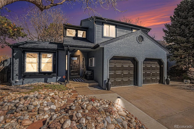 traditional-style house featuring a garage, brick siding, and driveway