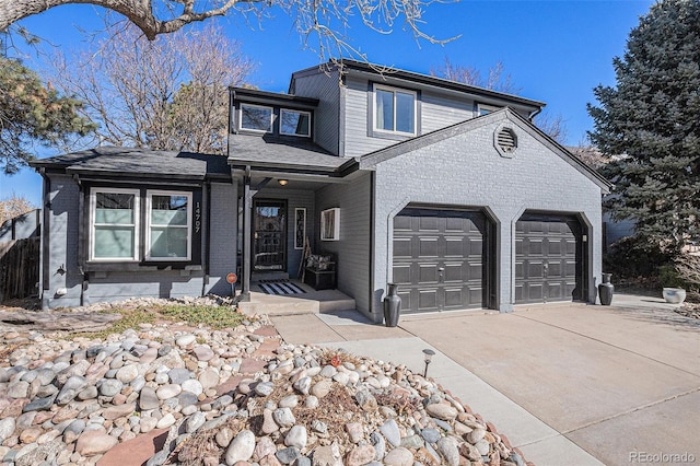 traditional home featuring concrete driveway, a garage, and brick siding