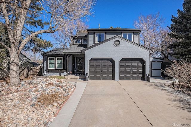 view of front of property with brick siding, an attached garage, and driveway