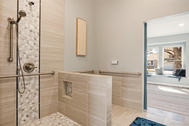 bathroom with tile patterned floors and a tile shower