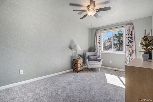 unfurnished room featuring visible vents, baseboards, carpet, a textured ceiling, and a ceiling fan