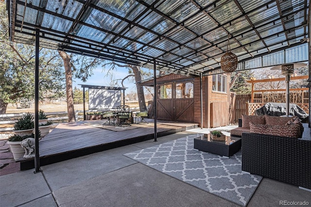 view of patio with a deck, an outdoor structure, outdoor dining area, and outdoor lounge area