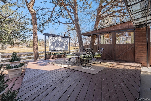 wooden terrace with outdoor dining space