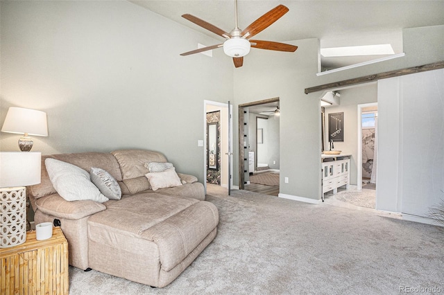 living room with ceiling fan, high vaulted ceiling, and carpet