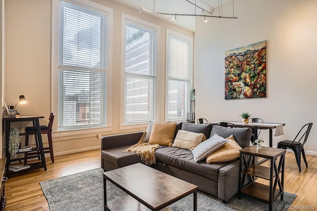 1555 California St Unit 304, Denver, CO 80202 - living area featuring light wood-style floors, plenty of natural light, and baseboards