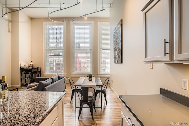 1555 California St Unit 304, Denver, CO 80202 - dining room featuring light wood-style floors, plenty of natural light, and baseboards