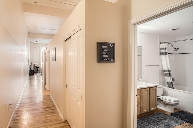 1555 California St Unit 304, Denver, CO 80202 - hallway featuring light wood-type flooring, a sink, and baseboards