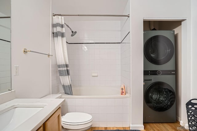 1555 California St Unit 304, Denver, CO 80202 - full bath with stacked washing machine and dryer, tiled shower / bath combo, toilet, vanity, and wood finished floors
