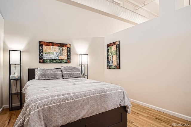 1555 California St Unit 304, Denver, CO 80202 - bedroom with baseboards and light wood-style flooring