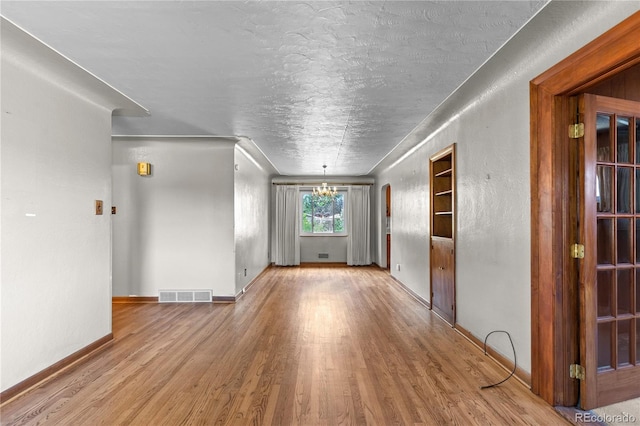 4815 S Pennsylvania St, Englewood, CO 80113 - unfurnished room with wood finished floors, a chandelier, and a textured ceiling