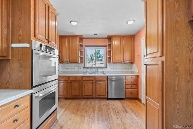 4815 S Pennsylvania St, Englewood, CO 80113 - kitchen featuring appliances with stainless steel finishes, open shelves, light wood finished floors, decorative backsplash, and light countertops