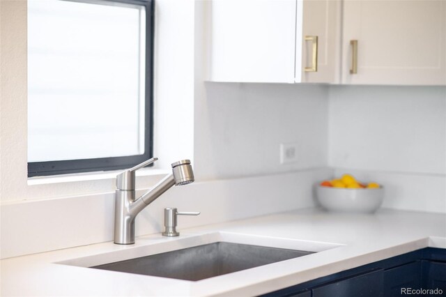 3069 Tejon St Unit B, Denver, CO 80211 - kitchen view of blue cabinetry, white cabinets, and light countertops