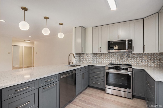 460 S Marion Pkwy Unit 604, Denver, CO 80209 - kitchen featuring appliances with stainless steel finishes, gray cabinetry, a peninsula, and tasteful backsplash