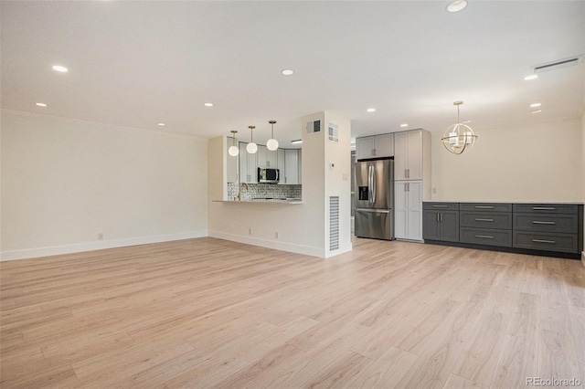 460 S Marion Pkwy Unit 604, Denver, CO 80209 - unfurnished living room featuring light wood-style floors, a chandelier, and recessed lighting
