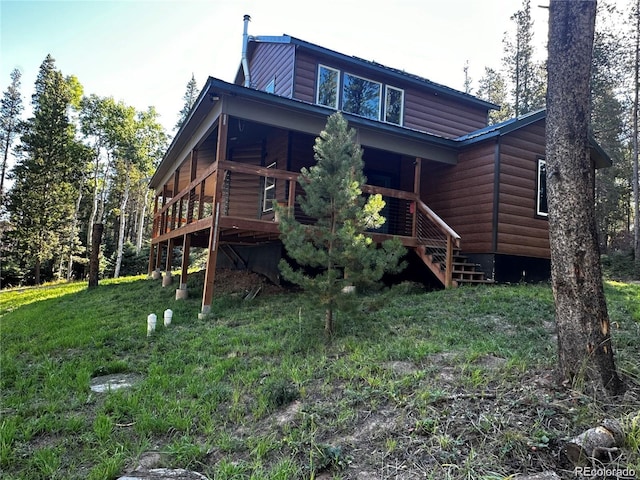 back of property featuring faux log siding