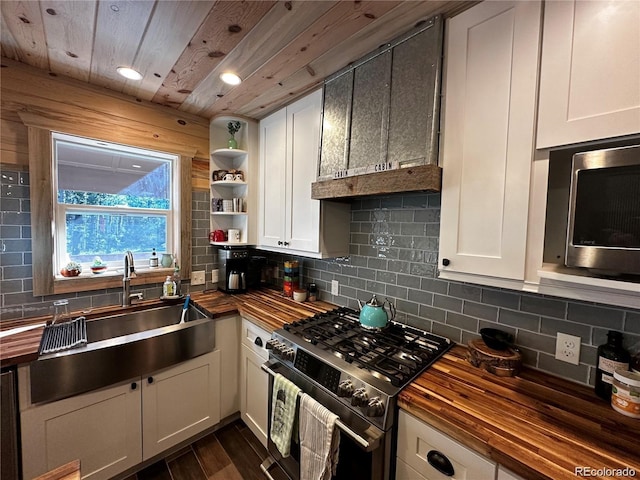 kitchen featuring butcher block countertops, backsplash, and appliances with stainless steel finishes