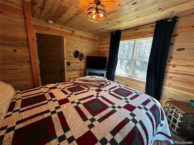 bedroom with wood ceiling and wood walls