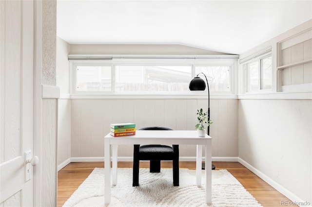 office with baseboards, lofted ceiling, and wood finished floors