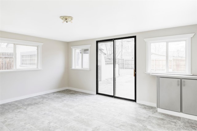 unfurnished room featuring baseboards