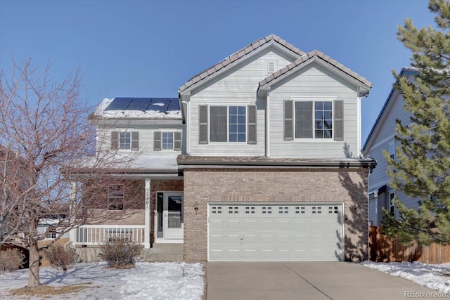 front of property featuring a garage and solar panels