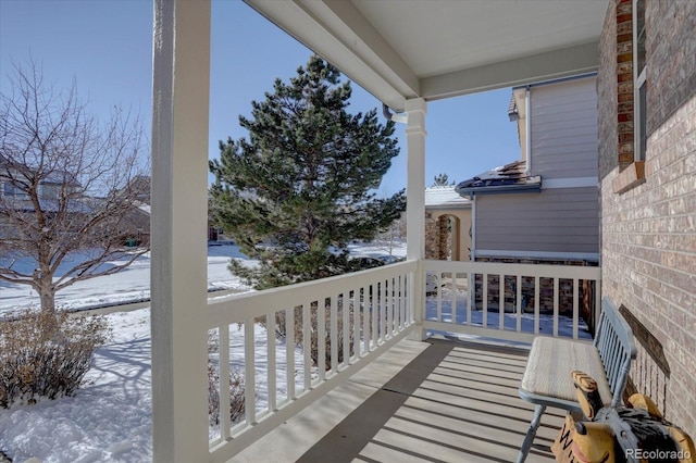 view of snow covered back of property