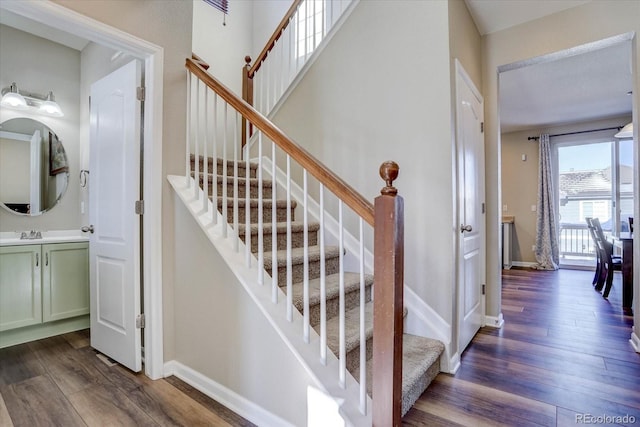 stairway with hardwood / wood-style flooring