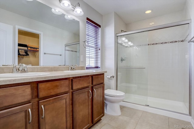 bathroom with toilet, an enclosed shower, vanity, and tile patterned floors