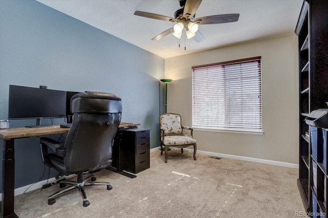 carpeted home office featuring ceiling fan