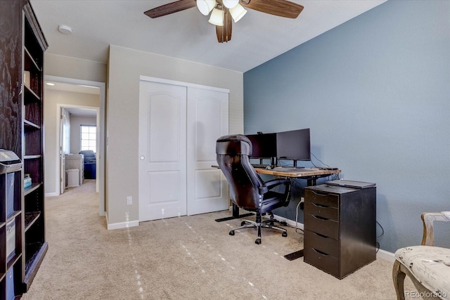 carpeted home office with ceiling fan