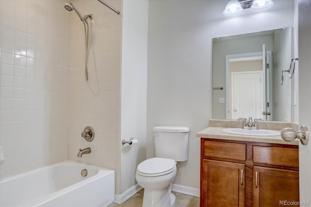 full bathroom featuring toilet, tiled shower / bath, and vanity