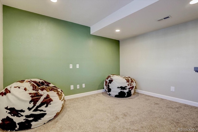 living area featuring carpet