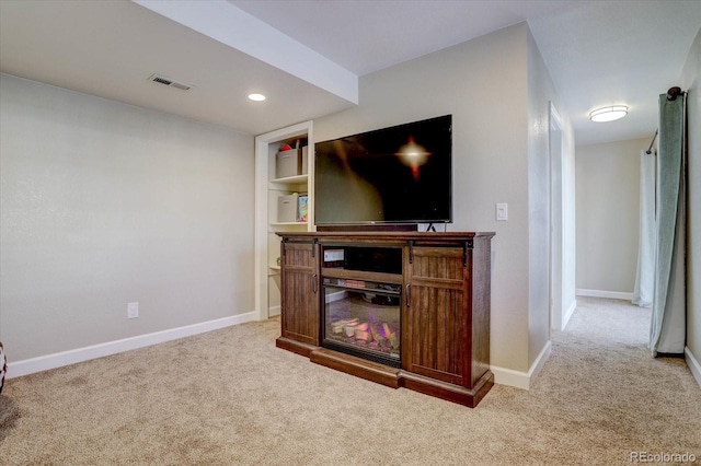 living room featuring built in features and carpet