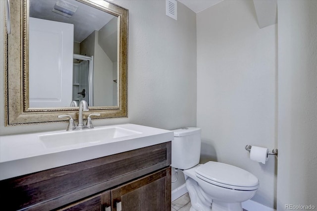 bathroom with toilet and vanity