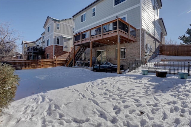 snow covered property featuring a deck