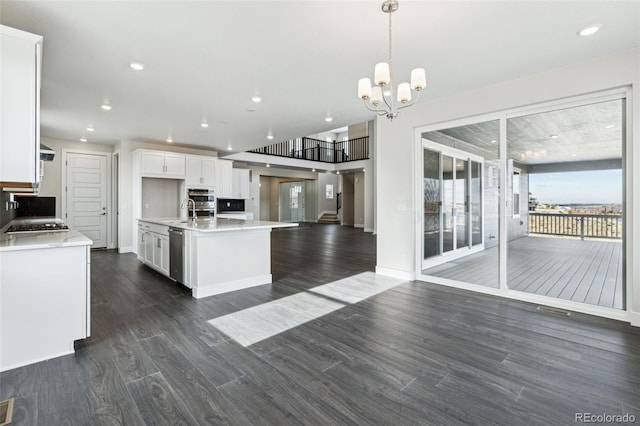 5566 Hickory Oaks Trl, Castle Rock, CO 80104 - kitchen featuring open floor plan, dark wood finished floors, light countertops, white cabinetry, and appliances with stainless steel finishes