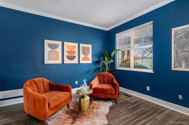 living area featuring visible vents, crown molding, baseboards, and wood finished floors